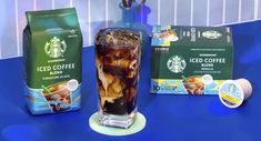 starbucks iced coffee and ice tea on a blue countertop next to two bags of coffee