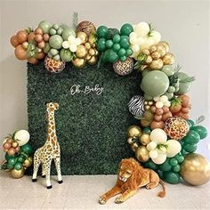 a giraffe and a lion are sitting in front of a backdrop with balloons