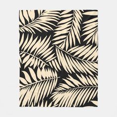 a black and white palm leaf pattern on a square rug with an off - white background