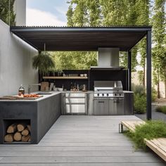 an outdoor kitchen with stainless steel appliances and wood planks on the floor, surrounded by trees