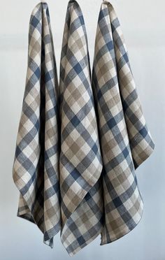 three blue and white checkered towels hanging from hooks