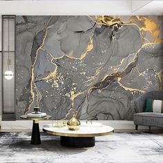 an elegant living room with marble walls and flooring, gold accents on the coffee table