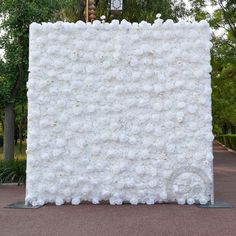 a large white sculpture sitting in the middle of a park