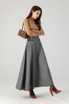 This grey winter wool skirt is a classic piece of tailoring that will see you through rain or shine. It is cut with a flattering flared skirt to give you a wonderful shape. The winter skirt is perfect classic styling and ends at the ankle.  DETAILS: * 30% wool, 30% fiber, 40% polyester * Fully satiny liner * Two side pockets * Right zipper closure * Maxi wool skirt,long skirt * A line skirt, swing skirt * High waist skirt * Daily skirt * Perfect for Winter, autumn * Dry clean * Lean More about the items From the FAQs on the page bottom MODEL SIZE Bust 85 cm(33.4") Waist 67 cm(26.7") Height 168cm (5' 6") She wears size XS Choose CUSTOM Order if you * Need a better fit * Can't find your size in our size Chart * Change the Style * Chang the Length * Your Height is not Between 5'1" - 5"9" * Yo Maxi Wool Skirt, Wool Maxi Skirt Outfit, Winter Wool Skirt, Custom Skirt, Long Wool Skirt, Classic Capsule Wardrobe, Skirt A Line, Maxi Skirt Outfits, Ankle Length Skirt