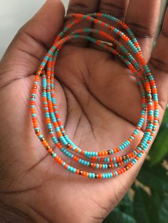 "~OBAA SWEETIE~ Handcrafted waist beads for ALL body types. These waist beads are designed to be tied on for long term wear. Obaa means \"woman\" in the Akan language of Ghana, translating Obaa Sweetie to \"Sweet woman.\" The color turquoise represents self-awareness. Orange symbolizes courage and vitality, and bronze exudes nature's aura and ideas of growth and strength. This listing is for ONE WAIST BEAD STRAND PER QUANTITY PURCHASED. Bead size 11 (small), giving off a dainty look. Know your m Bohemian Hand-strung Waist Beads With Round Beads, Bohemian Heishi Beaded Waist Beads, Colorful Heishi Waist Beads, Bohemian Tiny Beads Waist Beads For Festival, Handmade Bohemian Waist Beads With Oval Beads, Handmade Oval Waist Beads For Festivals, Bohemian Handmade Oval Beads Waist Beads, Bohemian Handmade Oval Waist Beads, Colorful Waist Beads For Festivals