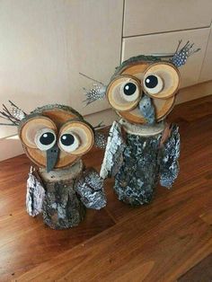 two owls made out of tree stumps sitting on top of a wooden floor