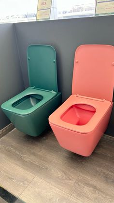 two toilets sitting next to each other in a bathroom