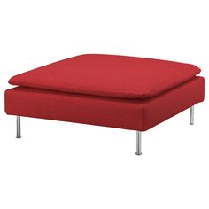 a red ottoman sitting on top of a metal frame