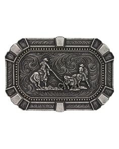 Team Roper Classic Belt Buckle Our medium sized rectangular buckle features cut corners and traditional western engraving patterns. The center features a team roping figure framed with traditional deco flourishes in alternating light and darker silver tones around the corners and edges in a bold attitude fashion. Classic western filigree markings decorate the back for added detail. It has a standard 1.5" swivel and is made of silver over a solid cast metal alloy base. Measures 4" x 2.75". Top off your favorite outfit with this Team Roping Attitude Belt Buckle and you will be ready to hit the town in style. Western Antique Belt Buckles In Rectangular Shape, Western Antique Rectangular Belt Buckle, Western Style Rectangular Antique Belt Buckle, Western Picture Frames, Engraving Patterns, Smith And Western, Team Roper, Western Rings, Western Bracelets