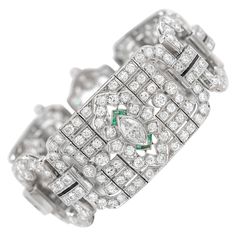 The art deco bracelet is finely crafted in platinum with round diamonds weighing approximately total of 20.00 carat and marquise diamonds weighing approximately total of 2.00. On the side there are also emeralds and onyx. Circa 1930's. Art Deco Platinum Tennis Bracelet With Diamond Accents, Art Deco Platinum Diamond Bracelet, Formal Art Deco Diamond Tennis Bracelet, Art Deco Diamond Bracelet In White Gold, Art Deco Cubic Zirconia Diamond Bracelet For Formal Occasions, Art Deco White Gold Diamond Bracelets, Art Deco Style Formal Cubic Zirconia Diamond Bracelet, Timeless Platinum Bracelets For Evening, Art Deco White Gold Tennis Bracelet With 17 Jewels