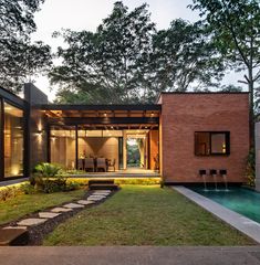 a house with a swimming pool in the middle of it's yard and landscaping