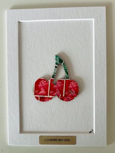 a piece of paper cut into two cherries