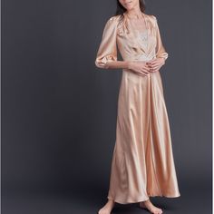 The lovely Maia dressing gown features a 100% silk charmeuse body with custom 18K gold twice-plated buttons at the robe waist and sleeve for closure. There is a feminine French lace appliqué detail at the back of the waist and also at the front of the waistband, and a soft billow to the three-quarter length sleeve. Product Details 100% silk charmeuse. 18k gold twice-plated buttons. Made in the USA. Care Instructions We recommend hand-laundering your LFrank lingerie using a delicate detergent or lingerie-specific wash in cold water. Please hang or lay flat to dry, and steam as necessary. Dry cleaning is also an option, if you prefer. Size & Fit This item fits true to size. Shipping Details Please allow 3 weeks for production and 5-7 days for standard delivery. Return Policy This item is ava Silk Robe, Silk Charmeuse, Dressing Gown, Over The Moon, French Lace, Lace Applique, Night Gown, Gowns Dresses, Length Sleeve