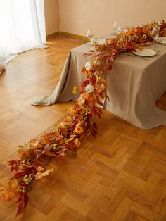 the table is set with plates and place settings for an autumn themed dinnereon party