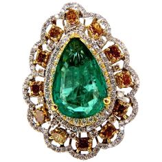 Green Pear Allure. 8.63ct. Natural GIA Certified Emerald Ring GIA Certified Report ID: 5161616364 18.78 X 12.46 X 5.71mm Full cut pear brilliant Clean Clarity & Transparent Vivid Green / Zambia Best GIA= "F2" 12 Natural Fancy color Diamonds. Ovals, Cushions & Pear all full cut brilliants Fancy Color yellow orange brown Vs-2 clarity. 2.00ct round, white diamonds G-color Vs-2 clarity. 18kt. white gold 19.2 grams Ring Current size: 7.5 Depth of ring: .53 inch Deck of ring: 1.44 X 1.08 inch (Free Resize Service, Please inquire) Video upon request. $60,000 Appraisal Certificate to accompany & GIA Pink Diamond Halo Ring, Emerald Diamond Ring, Diamond Cocktail Rings, Fancy Color Diamonds, Gems Jewelry, Zambia, Yellow Diamond, Natural Emerald, Pink Diamond