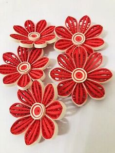 six red flower shaped buttons with white centers