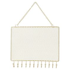 a gold metal wall hanging with hooks and pegs on the side, in front of a white background