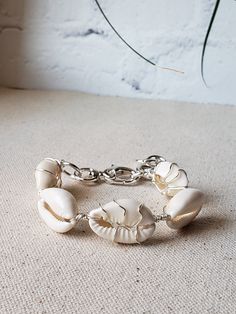 Summer ready bracelet with the prettiest cowries. Alternating wire wrapped cowries using your choice of gold plated or silver plated wire. Bold toggle clasp, and thick jumprings make this bracelet stand out. The additional jumprings also act as and an extender so it fits from 6.5" to 8.5" wrist.  Comes boxed and ready for gifting. Adjustable Cowrie Shell Bracelet Jewelry, Adjustable Cowrie Shell Bracelet, Shell-shaped Jewelry With Lobster Clasp, Adjustable Chain Beaded Bracelets For Beach, Adjustable Chain Bracelet For Beach, Beach Jewelry With Adjustable Chain Bracelet, White Bohemian Bracelet With Adjustable Chain, Elegant Metal Bracelets For Beach, Elegant Handmade Bracelets For Vacation