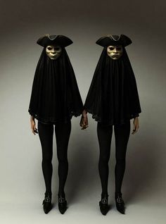 two women dressed in black and white are standing next to each other