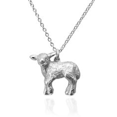 a silver sheep necklace on a chain with a small animal charm hanging from it's neck