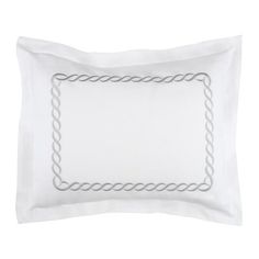 a white pillow with an embroidered border