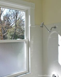 a bathroom with a shower, tub and window in it's corner is shown