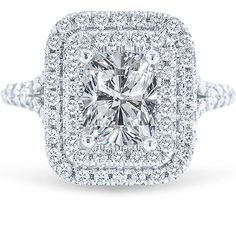 a cushion cut diamond surrounded by halos and pave diamonds on a white background