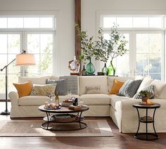 a living room filled with furniture and lots of windows