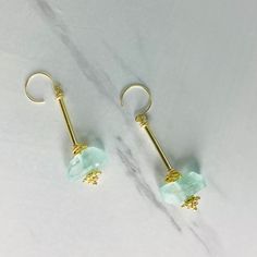 We think you'll love the light weight, unique design of our Aegean Sea Glass Earrings 🌊 Sea glass nuggets in translucent light blue sandwiched between our champagne gold hardware. All metals are copper based with a champagne gold tone electroplate and tarnish resistant finish, free from cadmium, lead, and nickel. Earrings measure 2.5 long. Gold Electroformed Drop Earrings, Luxury Gold Electroformed Drop Earrings, Gold Wire Wrapped Glass Earrings, Elegant Recycled Glass Jewelry For Jewelry Making, Gold Aquamarine Teardrop Jewelry, Handmade Gold Aquamarine Earrings, Gold Teardrop Glass Earrings, Nickel-free Gold Earrings With Czech Glass, Nickel Free Gold Earrings With Czech Glass