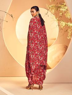 Featuring a red kalamkari printed kurta paired with a pickup dhoti and a cape. The neckline is fully embroidered by hand with french knot, pearlwork, cutdana and bead detail. The cape also features a fully hand embroidered border with dabka and oxidised metallic sequence Embroidered Border, French Knot, Hand Embroidered, Cape, Knot, Beads, Red