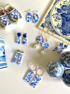 blue and white porcelain items are displayed on a table next to an ornament