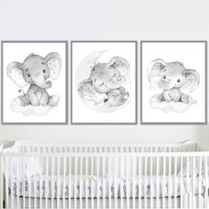 three elephants are hanging on the wall next to a crib in a baby's room