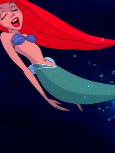 ariel from the little mermaid with her hair blowing in the wind while swimming under water