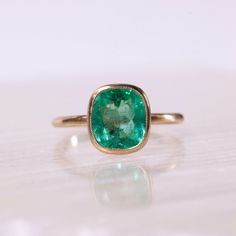 2.38ct Colombian emerald set in solid 14k recycled gold. Antique inspired designs with a brushed finish and minimal milgrain detail around the bezel. This ring would be stunning as an engagement ring or worn as an everyday right hand ring. This ring is currently a size 6 and eligible for a complimentary resize. Once resized, this ring is non-refundable and not eligible for return. If you would like to resize this ring from a size 6, please select your ring size in the drop down menu. Allow 2-3 weeks for processing. Timeless Bezel-set Emerald Ring For May Birthstone, Timeless Bezel Set Emerald Ring For May Birthstone, Timeless Emerald Ring With Bezel Setting For May Birthstone, Timeless May Birthstone Emerald Ring With Bezel Setting, Timeless Green Emerald Ring With Bezel Setting, Classic Emerald Ring With Smooth Bezel For Anniversary, Timeless Emerald Rings With Bezel Setting, Classic Yellow Gold Emerald Ring With Smooth Bezel, Classic Everyday Emerald Ring