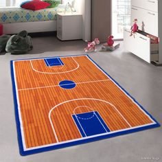 a child's bedroom with an orange and blue basketball court rug on the floor