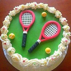 a cake decorated with tennis rackets and balls