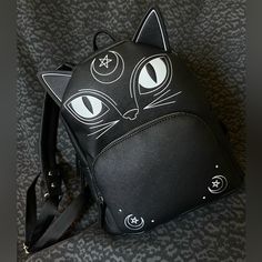 Got Lucky After Trying Multiple Stores For These Viral Halloween Purses And Found The Witchy Black Cat Mini Backpack Purse From Tj Maxx. This Was The Only Halloween Purse Left In The Store. Had To Have My Husband Guard It While I Grabbed Staff To Unlock It (He Said Someone Behind Him Was Eyeing It!). New With Tags & Tissue Stuffing Still Inside. Get It Before It’s Gone! Black Standard Backpack For Halloween, Black Halloween Standard Backpack, Black Backpack For Halloween Travel, Black Backpack For Halloween, Black Backpack For Halloween Cosplay, Black School Backpack With Cat Design, Black Halloween Backpack, Black Cat Design Backpack For School, Black Cat Design School Backpack