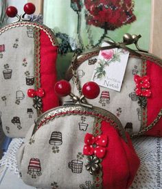 three red and white purses sitting on top of a table