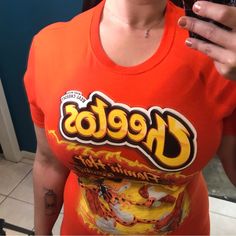 This Is A New Hot Topic Cheetos Shirt Men's Short Sleeve Graphic Tee - Works Well For Ladies Too! Hot Cheetos Graphic New Without Tags Size Small 100% Cotton This Shirt Measures 18" Across The Chest Lying Flat And 27" Long Orange Crew Neck Top With Graphic Print, Orange Graphic Print Tops For Streetwear, Casual Orange Tops With Graphic Print, Casual Orange Top With Graphic Print, Orange Letter Print Tops For Streetwear, Orange Graphic Print Top With Relaxed Fit, Fitted Orange Top For Streetwear, Fitted Orange Casual T-shirt, Orange Crew Neck T-shirt With Logo Print