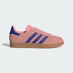 Once a training shoe, now a timeless icon, these adidas Gazelle shoes let you walk in the footsteps of history. This pair honors the original with a soft and supple suede upper and recognizable rubber outsole. Eye-catching colors lend modern style and pair well with casual outfits or sporty attire. Pink Gazelle, Pink Gazelles, Adidas Gazelle Shoes, Gazelle Shoes, Rose Adidas, Adidas Sambas, Bold Shoes, Adidas Originals Gazelle, Adidas Original