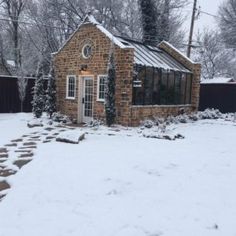 a small brick house covered in snow