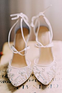 the brides shoes are adorned with swarozak and pearls for an elegant touch