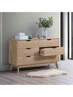 a wooden dresser sitting on top of a hard wood floor next to a white rug