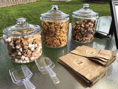 three glass jars filled with different types of food on top of a table next to each other