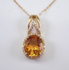 14K Yellow Gold Diamond and Citrine Necklace with Chain. This necklace is set with an Oval Citrine and forty natural Round Brilliant Diamonds.  The Citrine measures 12 x 10 mm. The diamonds in this pendant are H color, SI/I1 clarity.  The pendant is 14K Yellow Gold and comes with an 18" 14K Yellow Gold chain and together weigh 4.1 grams. The pendant measures 26 X 13 mm. This necklace will be accompanied by an appraisal written by a GIA Certified Diamond Grader with the retail replacement value of $1,789.00. I will ship this necklace promptly in a beautiful gift box. November Birthstone Jewelry, Citrine Pendant, Citrine Necklace, Halo Pendant, November Birthstone, Yellow Gold Chain, Diamond Pendant Necklace, Fine Jewellery Necklace, Brilliant Diamond