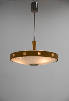 a circular light fixture hanging from a ceiling