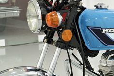 a close up of a motorcycle headlight on a motorbike in a showroom