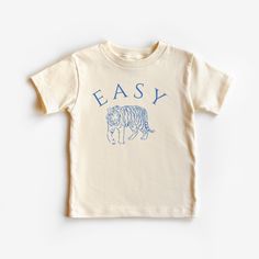 This cute toddler graphic tee is 100% cotton, has a tear away tag for your toddler's comfort and comes in 2 natural Bella Canvas colors. In sizes 2T-5T, make this cute easy tiger vintage inspired tshirt an everyday tee or gift for your toddler! DETAILS .100% Cotton .Bella Canvas tee .Tear away label .Runs true to size .Props in any photos are not included and are for styling purposes only .Colors may slightly vary from styled photos  SIZING This graphic tee design will be printed on a Bella Canv Playful Organic Cotton Graphic T-shirt, Cute Organic Cotton T-shirt For Everyday, Playful Organic Cotton T-shirt With Graphic Print, Playful Organic Cotton Graphic Print T-shirt, Playful White Organic Cotton T-shirt, Family Matching Soft-washed Short Sleeve T-shirt, Family Matching Cotton Graphic T-shirt, Cute Organic Cotton Screen Print Tops, Organic Cotton Pre-shrunk Graphic Tee