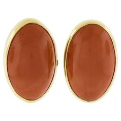 --Stone(s):-- (2) Natural Genuine Corals - Oval Cabochon Cut - Bezel Set - Reddish Orange Color - 28.94ctw (exact, certified) ** See Certification Details Below for Complete Info ** Material: Solid 18k Yellow Gold Weight: 11.58 Grams Backing: Posts w/ Omega Closures (Pierced ears are required.) Length: 23.5mm (0.92") Width: 15.4mm (0.60") Thickness: 8.9mm (at the coral) projection off the ear Condition: Vintage stones. New earrings. Comes with the original GIA certification for both of the coral