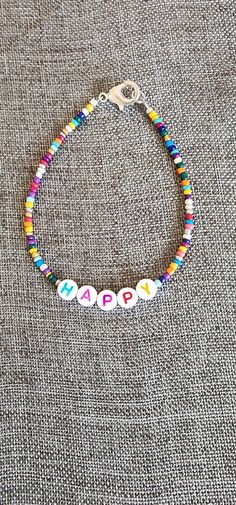 Rainbow beaded happy inspiration bracelet. 7.5 inches Trendy Bracelet Ideas, Funky Beaded Bracelets, Cheerful Handmade Adjustable Beaded Bracelets, Inspirational Multicolor Beaded Jewelry, Colorful Beads Friendship Bracelets For Birthday, Trendy Beaded Bracelet For Birthday, Trendy Beaded Bracelets For Birthdays, Casual Beaded Bracelets For Birthday, Multicolor Letter Beads Friendship Bracelets For Birthday Gift